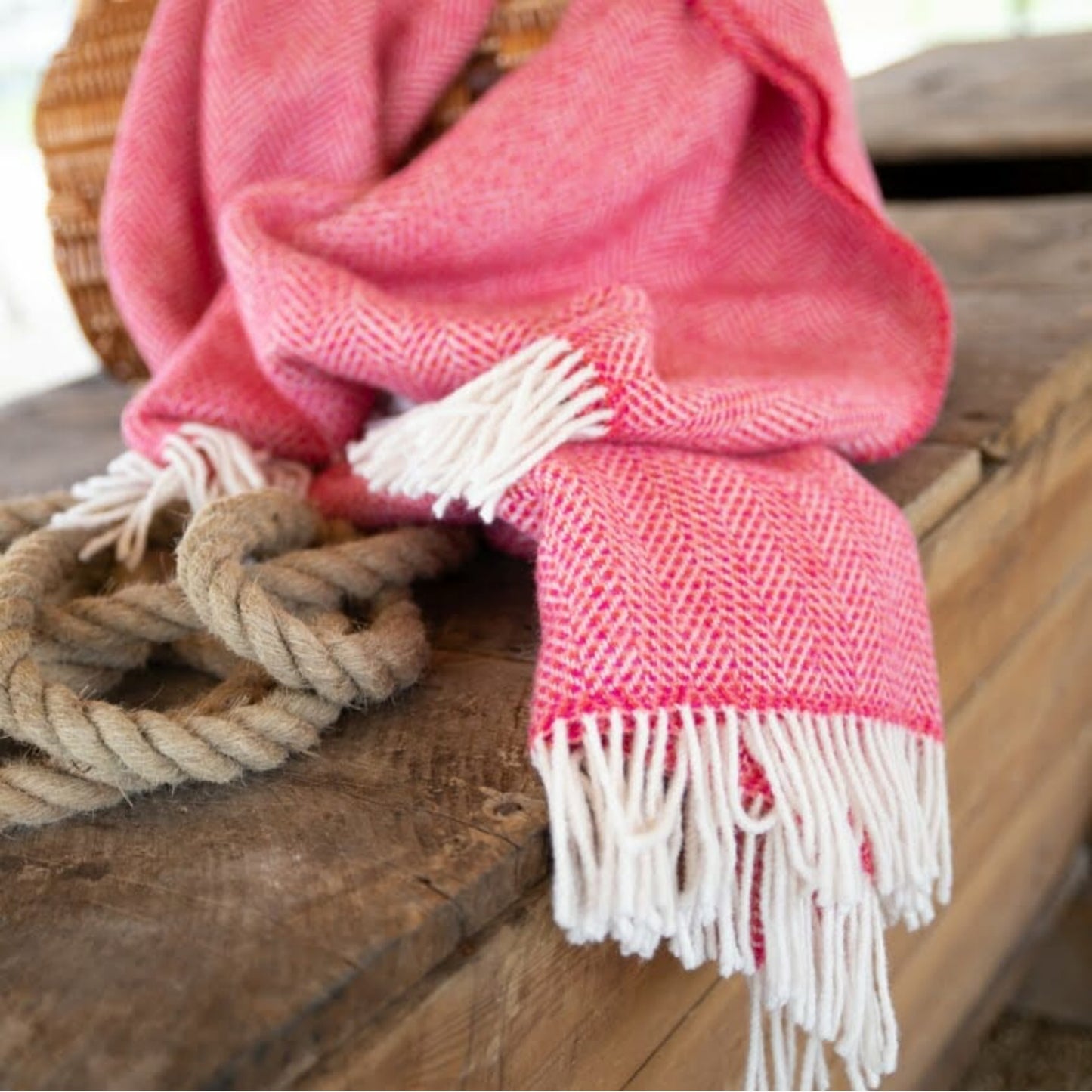 John Hanly Irish Cashmere Throw Blanket | Raspberry Herringbone Pattern | Lifestyle: Cashmere Blanket on Wooden Bench | BeoVERDE Ireland