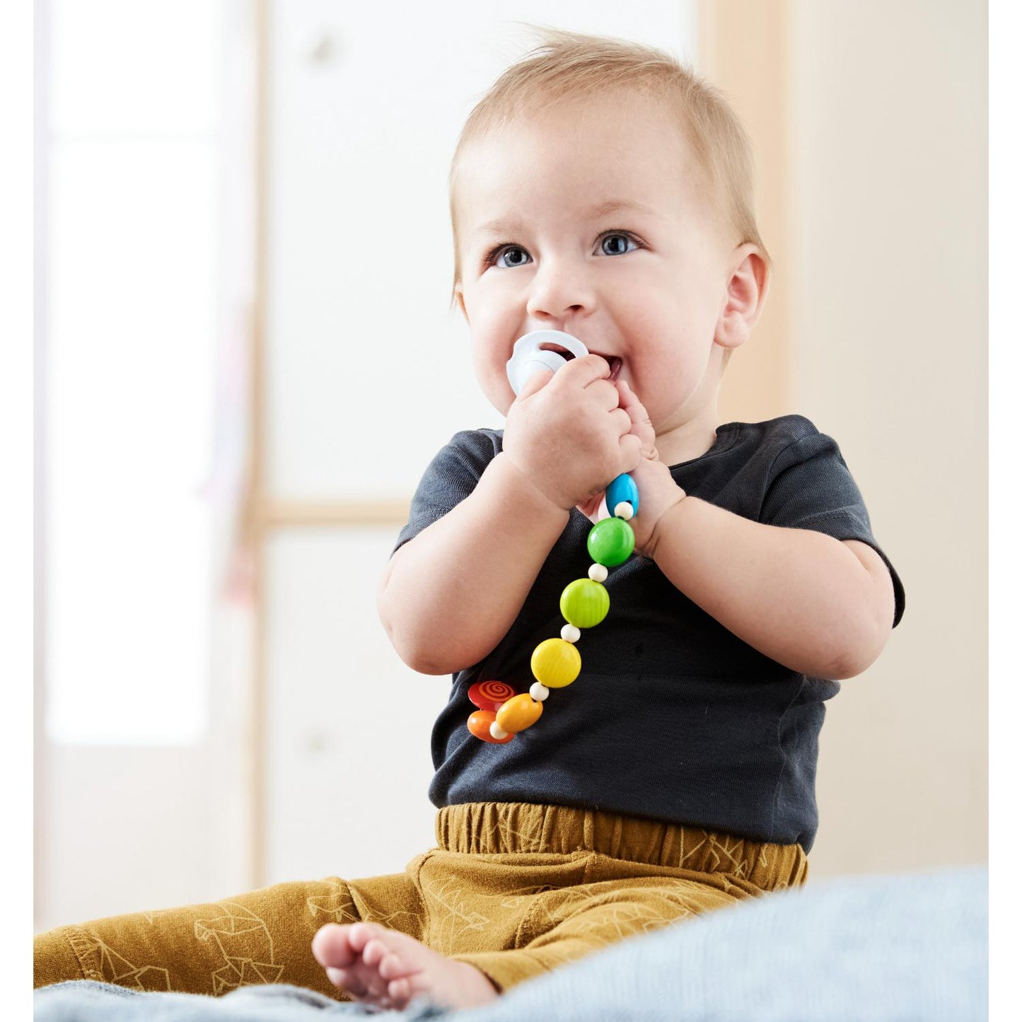 HABA Rainbow Wooden Dummy Clip | Lifestyle – Baby with Dummy Clip | BeoVERDE.ie
