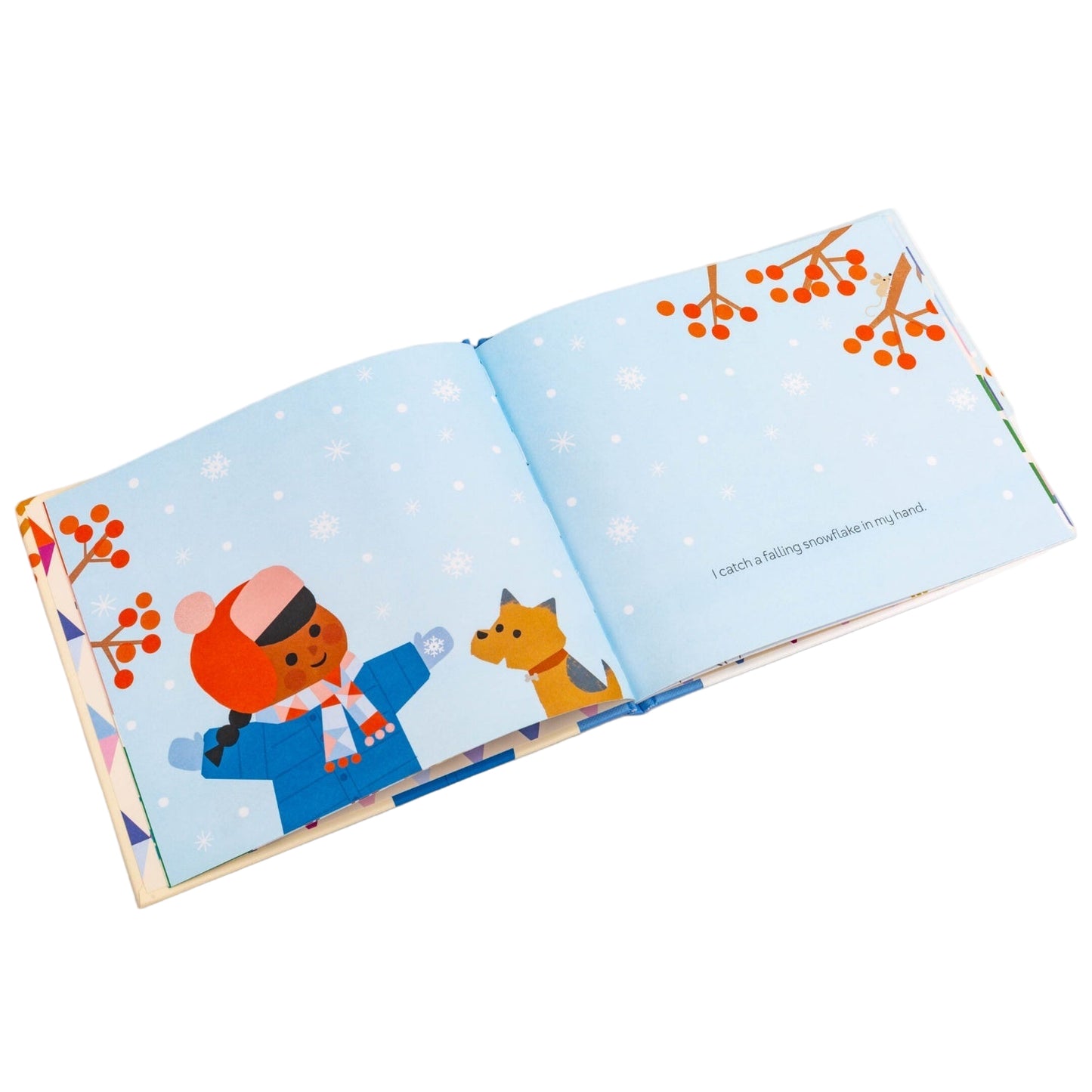 Illustrated book open to a page with two characters in winter clothing on a snowy background.