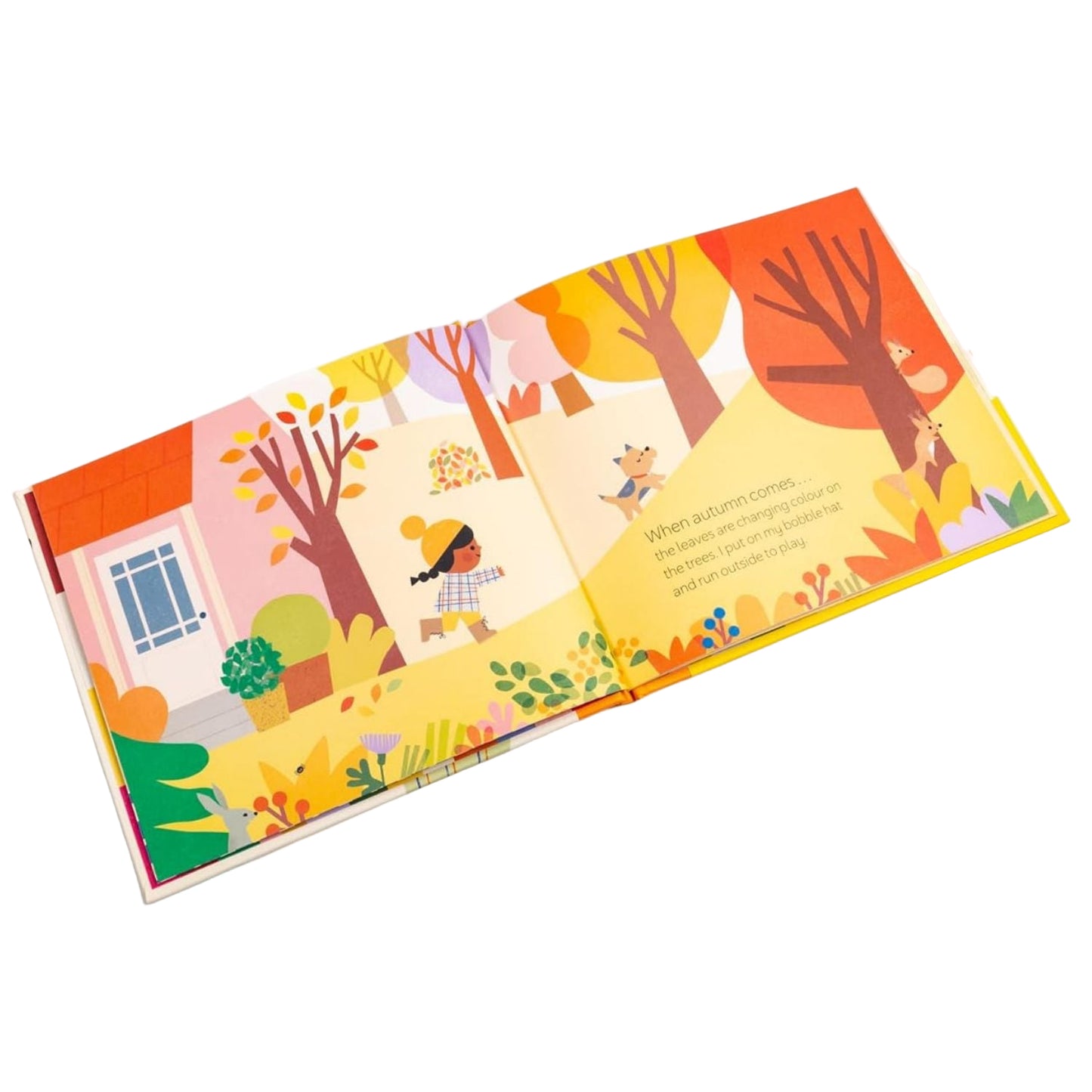 Illustrated children's book open to a page with autumn-themed scenes