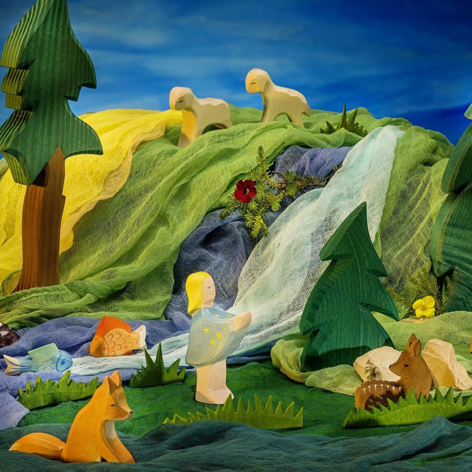 Toy scene with Ostheimer Startaler, animals and a waterfall in a forest setting