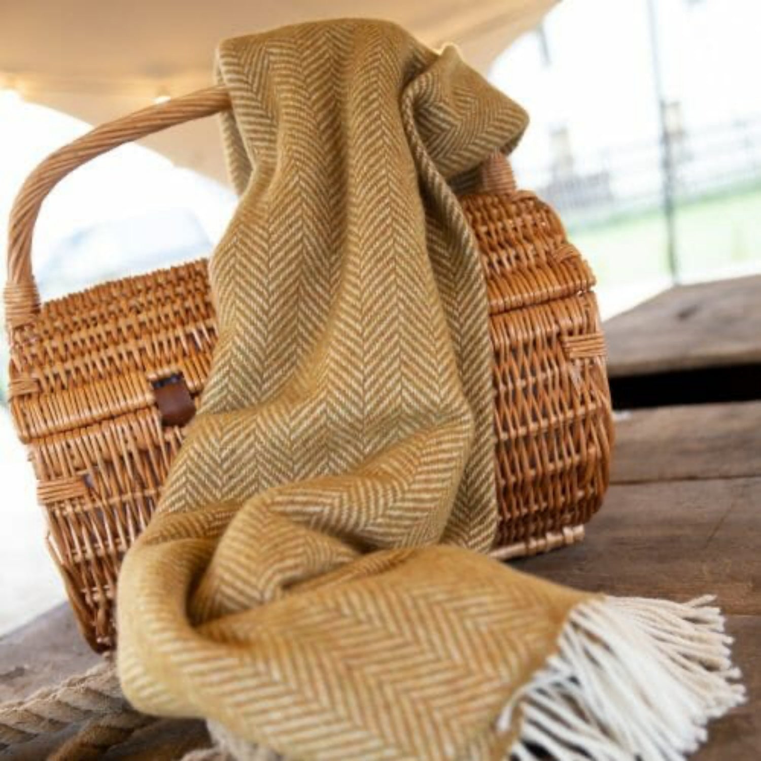 John Hanly Irish Cashmere Throw Blanket | Mustard Mix Herringbone Pattern | Lifestyle: Cashmere Blanket on Basket | BeoVERDE Ireland