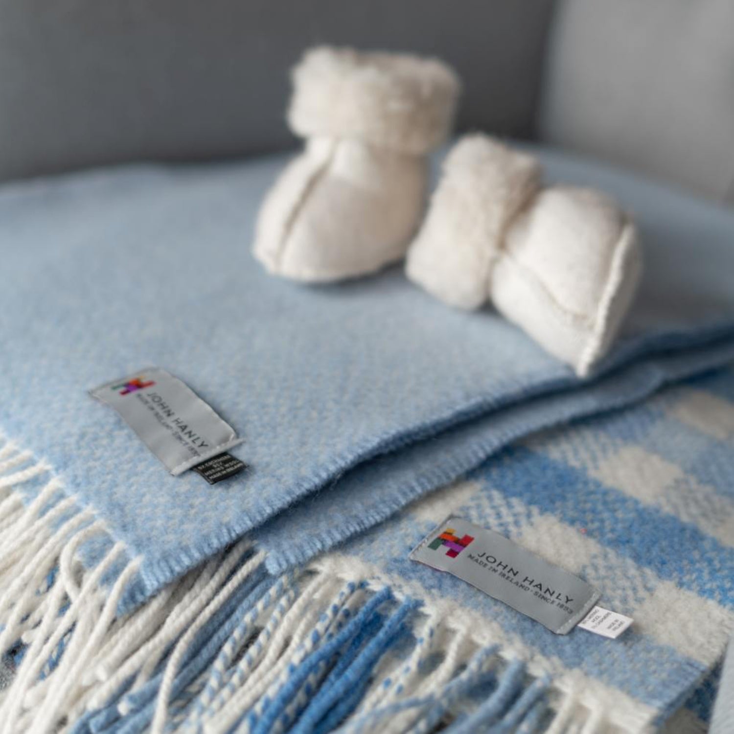 John Hanly Irish Cashmere Baby Blanket | Baby Blue Herringbone Pattern | Cashmere Blanket | Lifestyle: Baby Blanket on Bed | BeoVERDE Ireland