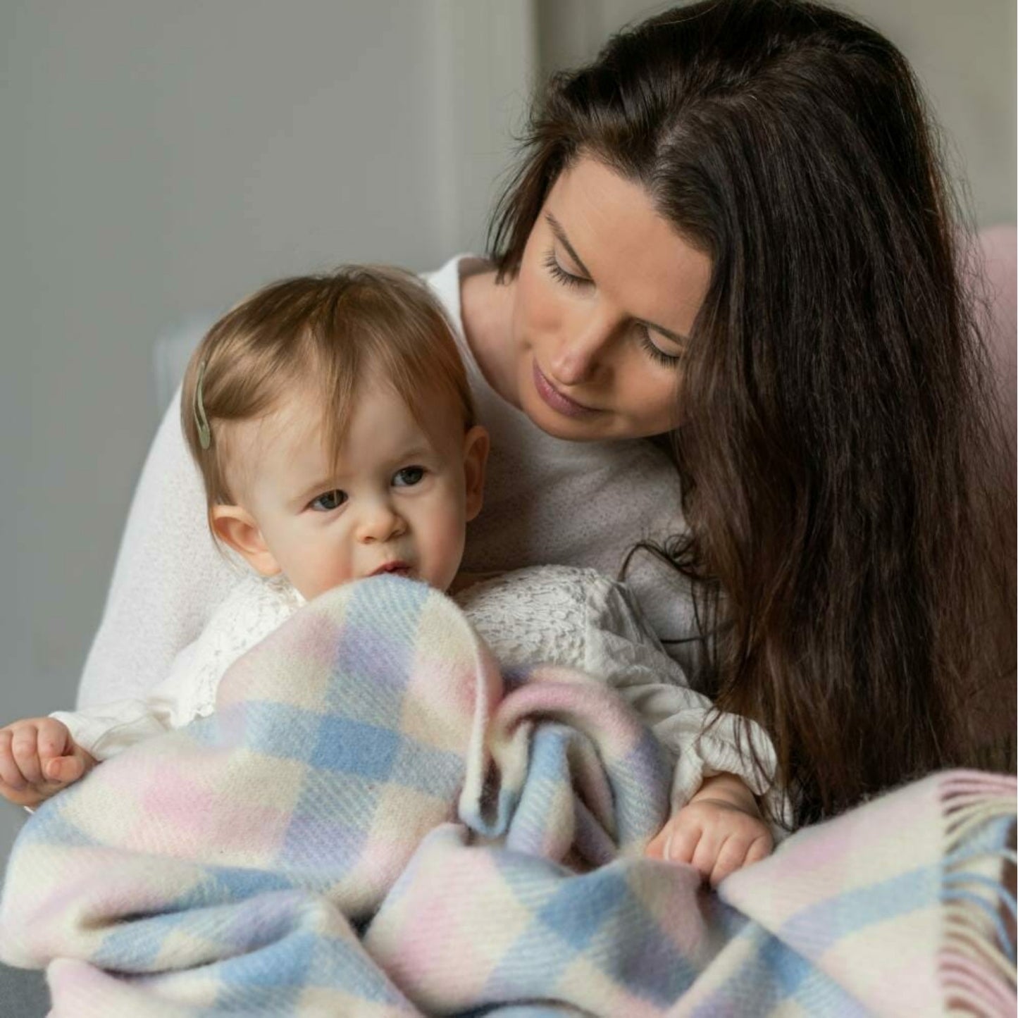 John Hanly Irish Wool Baby Blanket | White, Pink & Blue Border Block Check | 100% Pure Irish Wool Blanket | Lifestyle: Baby and Mother with Blanket | BeoVERDE Ireland
