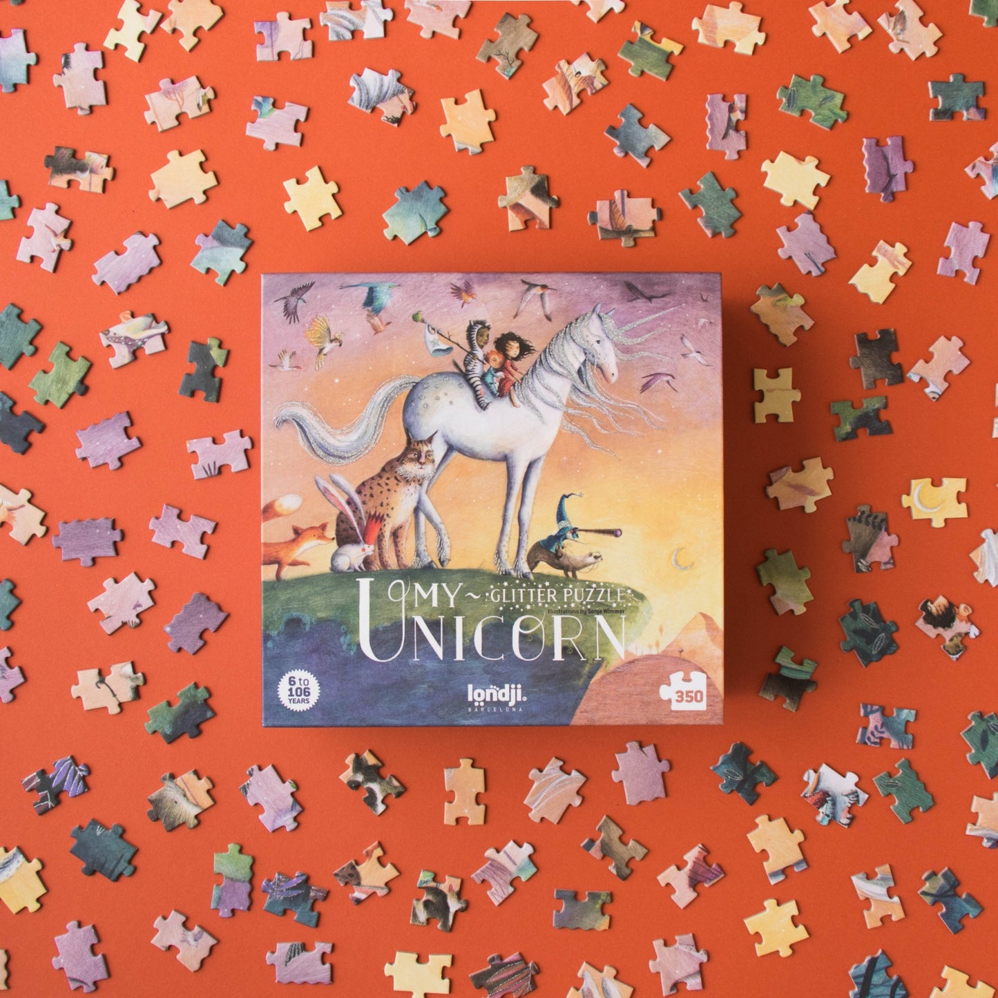Londji MY UNICORN Jigsaw Puzzle | Designed by Sonja Wimmer Jigsaw Puzzle | Perfect Jigsaw Puzzle for Kids 6 Years and Older and Adults | Front View – Box with Jigsaw Puzzle Pieces Around | BeoVERDE.ie