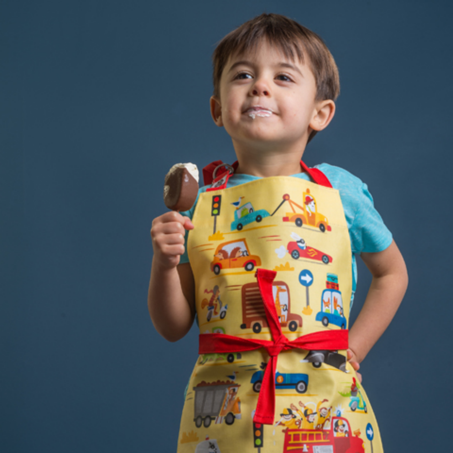 ThreadBear Design Children’s Apron ‘On The Move’ | Boy Wearing Apron and Eating Ice Cream | BeoVERDE.ie
