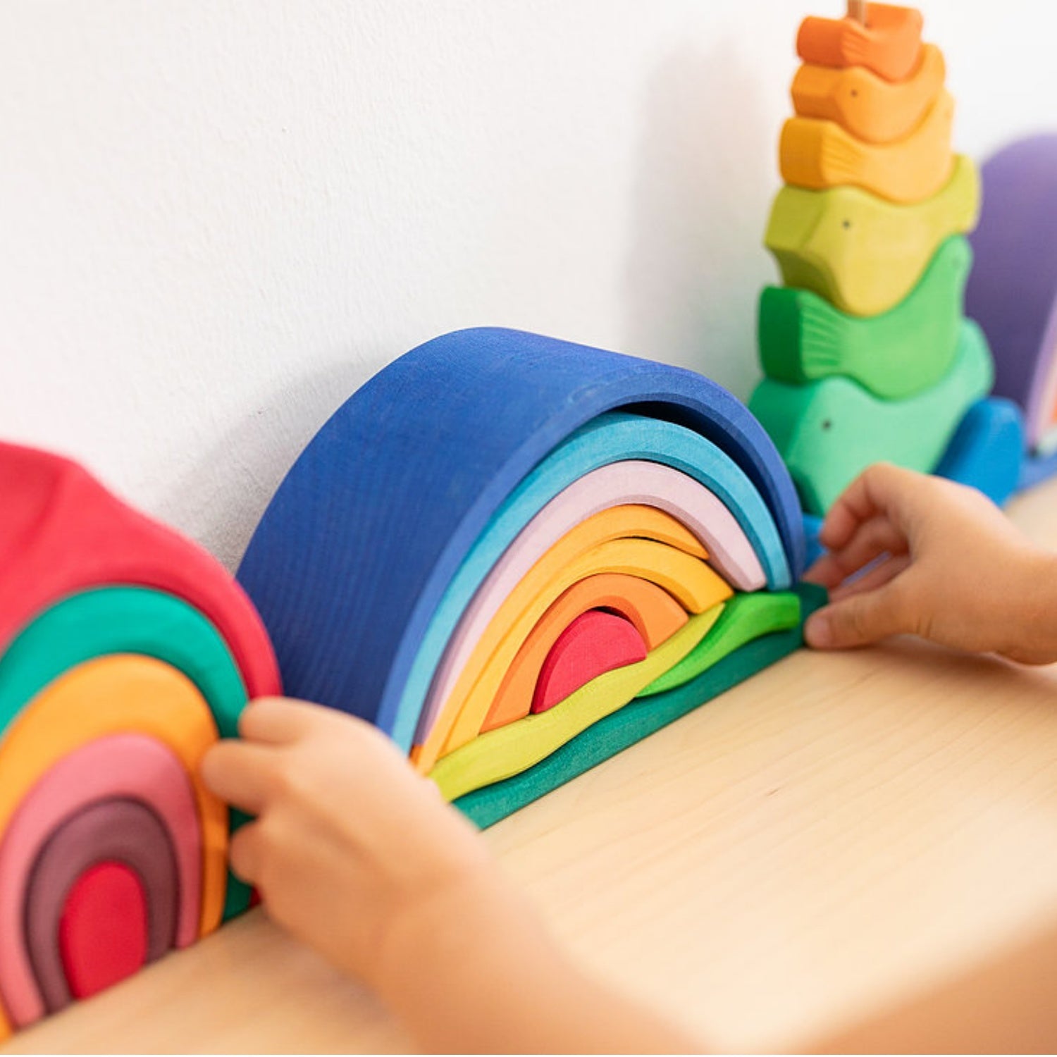 Gluckskafer Blue Wooden Sunrise Set | Imaginative Play Wooden Toys | Waldorf Education and Montessori Education | Lifestyle: Child Placing Blue Wooden Sunrise Set on Shelf | BeoVERDE.ie