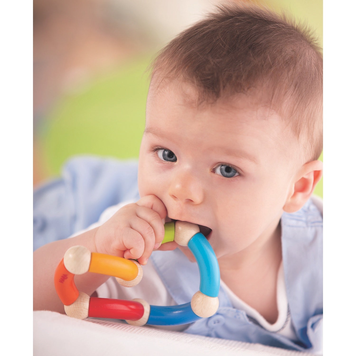 Trinity | Wooden Clutching Toy | HABA | Lifestyle: Baby Laying with Clutching Toy in Hand | BeoVERDE.ie