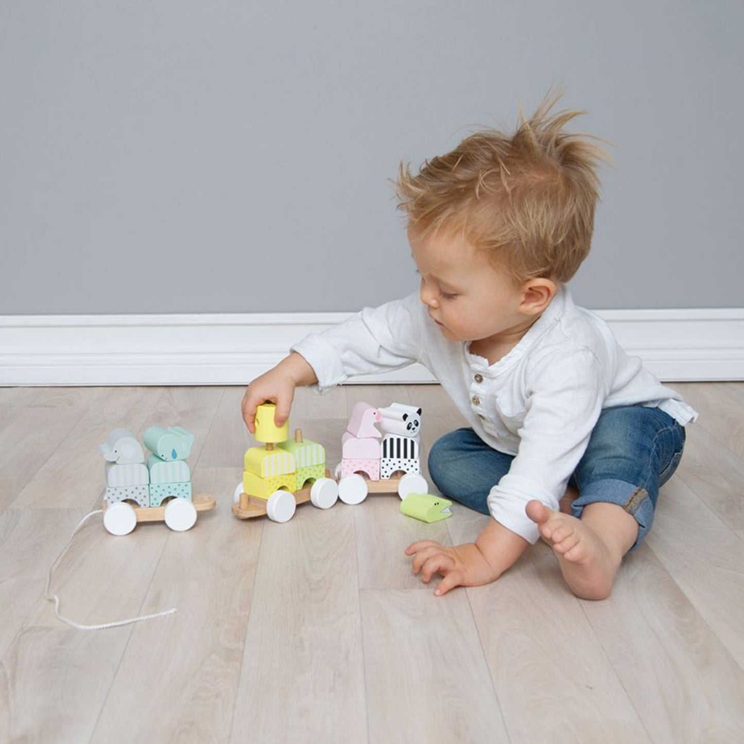 JaBaDaBaDo Pull Along Animal Stacker | Wooden Toddler Activity Toy | Lifestyle – Boy Playing | BeoVERDE.ie