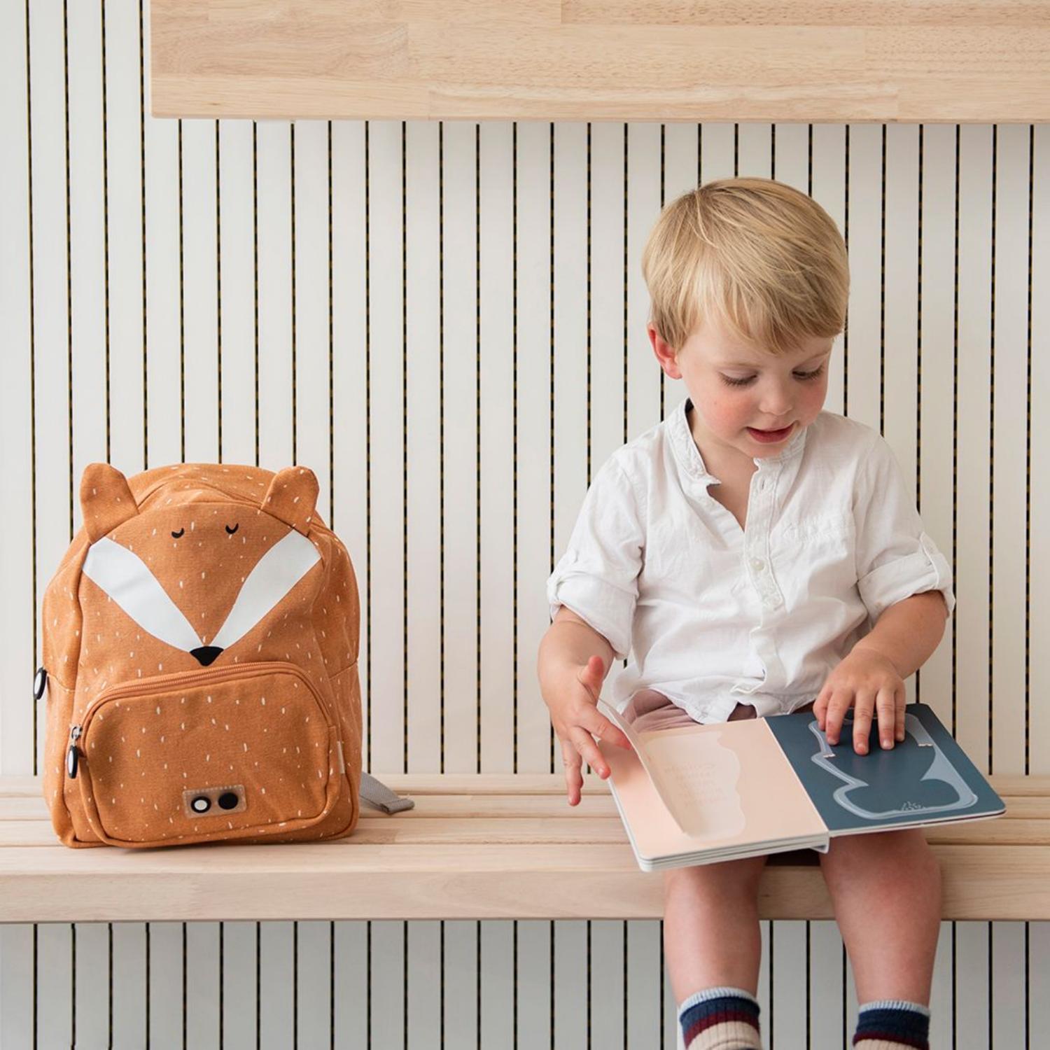 Trixie Mr. Fox Backpack | Kid’s Backpack for Creche, Nursery & School | Lifestyle: Boy Sitting on Bench with Backpack | BeoVERDE.ie