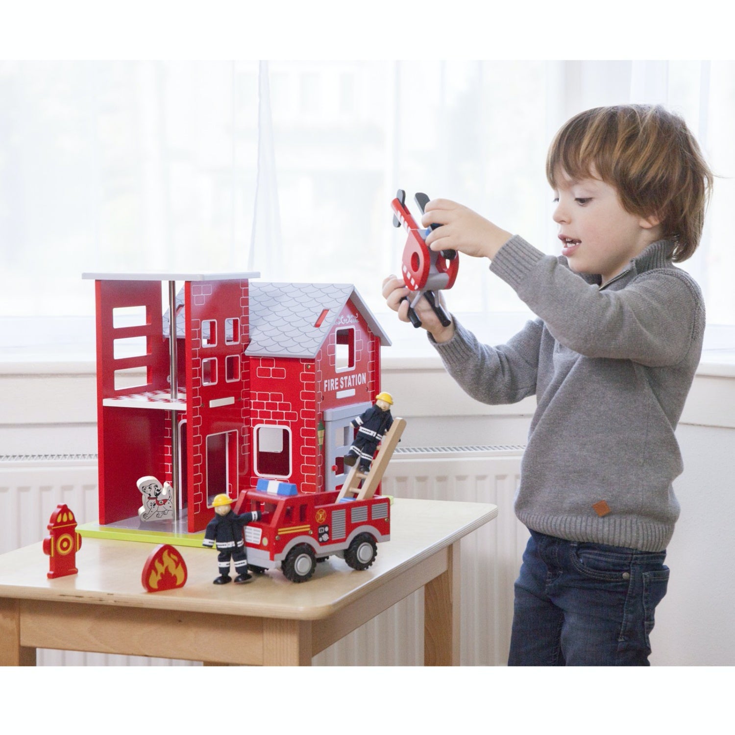 New Classic Wooden Toy Fire Station Play Set | Imaginative Play Toys | Lifestyle – Boy Playing with Wooden Figure | BeoVERDE.ie