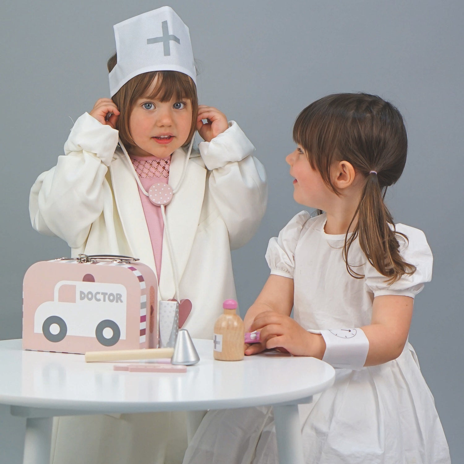 JaBaDaBaDo Doctor’s Case Pink | Wooden Pretend Play Toy | Lifestyle – 2 Girls Playing Stethoscope | BeoVERDE.ie