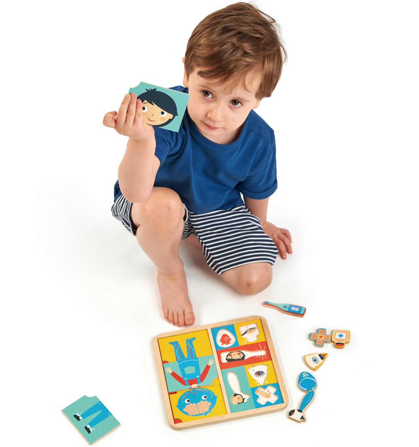 Tender Leaf Ouch Puzzle | Hand-Crafted Wooden Educational Toy | Boy Showing Puzzle Pieces | BeoVERDE.ie