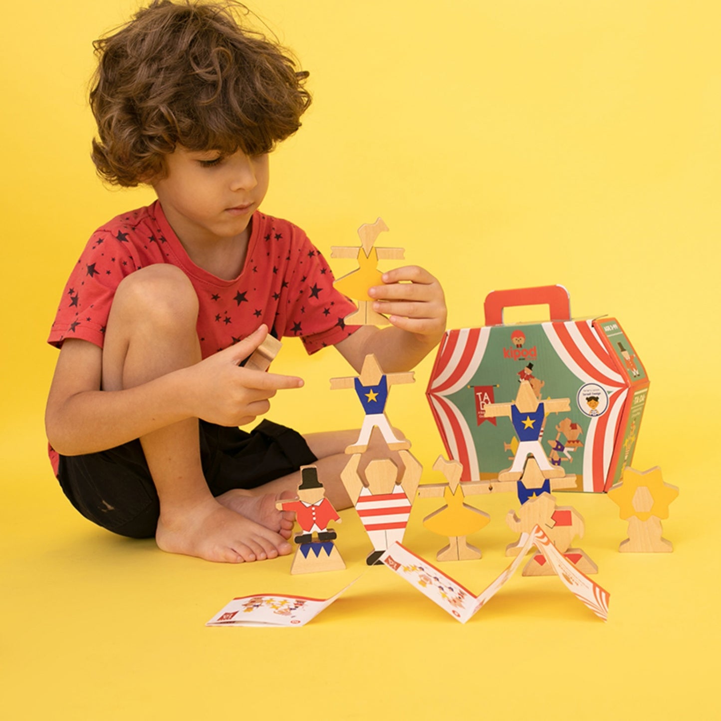 Kipod Toys  ‘Ta-Da’ Balancing Circus | Hand-Crafted Wooden Toy | Wooden Stacking and Balancing Game | Lifestyle – Boy Playing, Yellow Background | BeoVERDE.ie