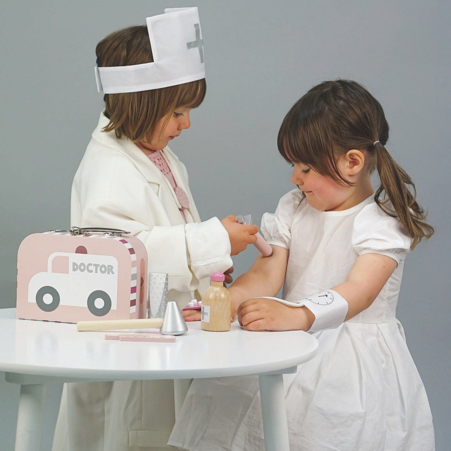 JaBaDaBaDo Doctor’s Case Pink | Wooden Pretend Play Toy | Lifestyle – 2 Girls Playing Injection | BeoVERDE.ie