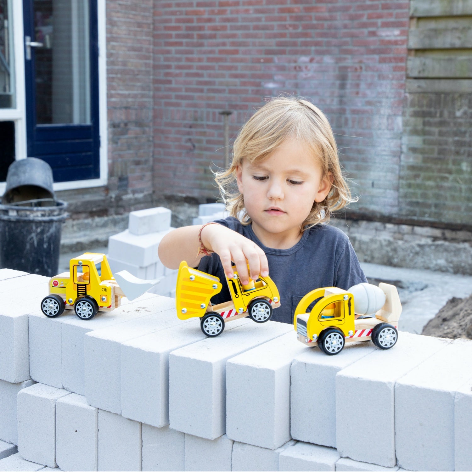 New Classic Toys Wooden Toy Construction Site Vehicle Set | Baby & Toddler Activity Wooden Toy | Lifestyle – Child Playing on Wall | BeoVERDE.ie